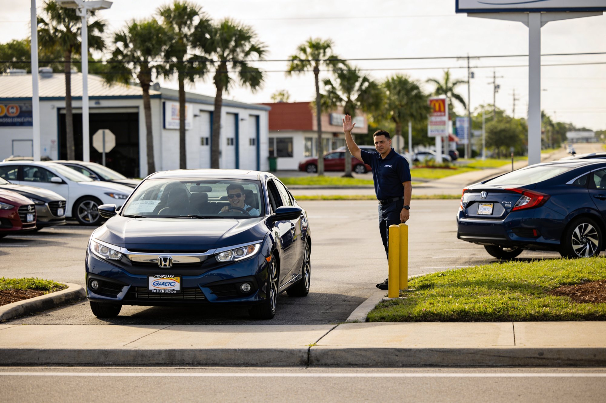 Happy customer driving away from Tampa Autohaus